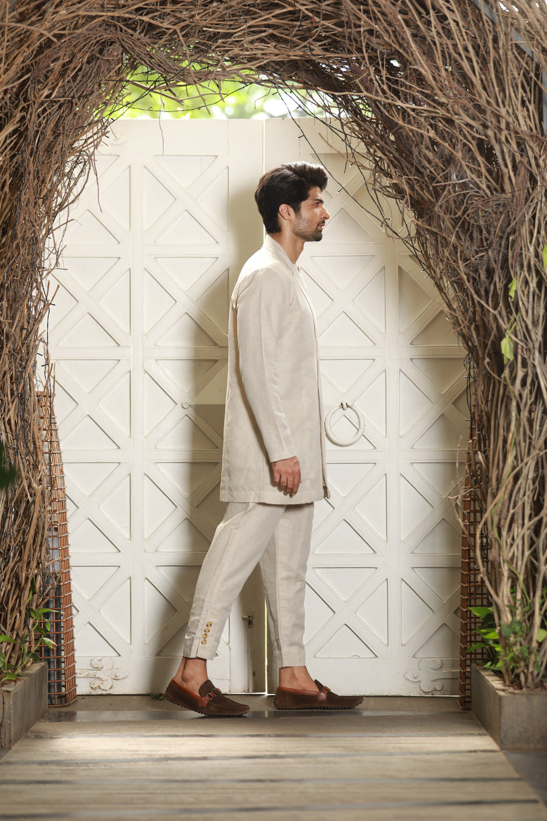 Ecru linen attached waist coat and jacket with narrow pants.