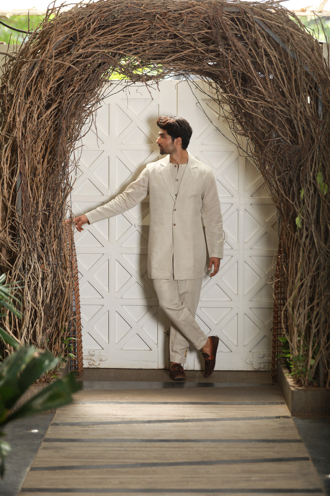 Ecru linen attached waist coat and jacket with narrow pants.