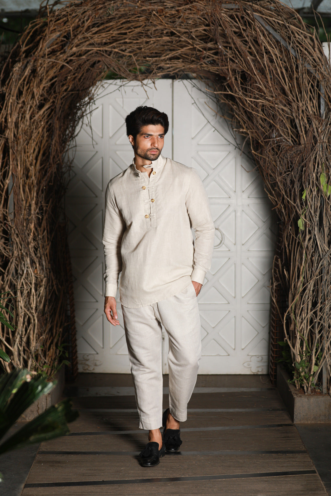 Ecru linen kurta shirt with narrow pants.