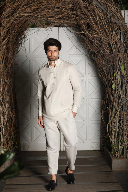 Ecru linen kurta shirt with narrow pants.