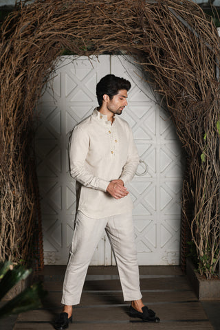 Ecru linen kurta shirt with narrow pants.