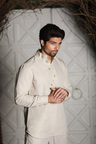 Ecru linen kurta shirt with narrow pants.