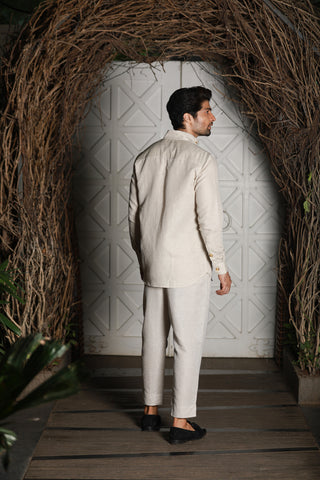 Ecru linen kurta shirt with narrow pants.