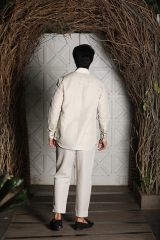 Ecru linen kurta shirt with narrow pants.