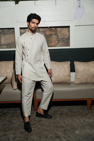 Ecru linen mandarin collar shirt with diagonal placket feature and narrow pants.