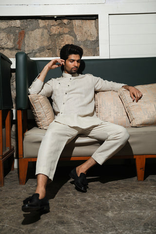 Ecru linen mandarin collar shirt with diagonal placket feature and narrow pants.