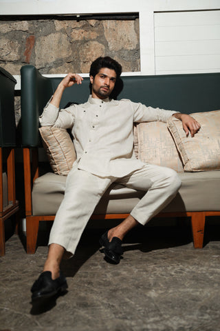 Ecru linen mandarin collar shirt with diagonal placket feature and narrow pants.