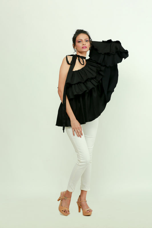 Black one shoulder top features a tie-up collar with ruffles and ruched cuff.