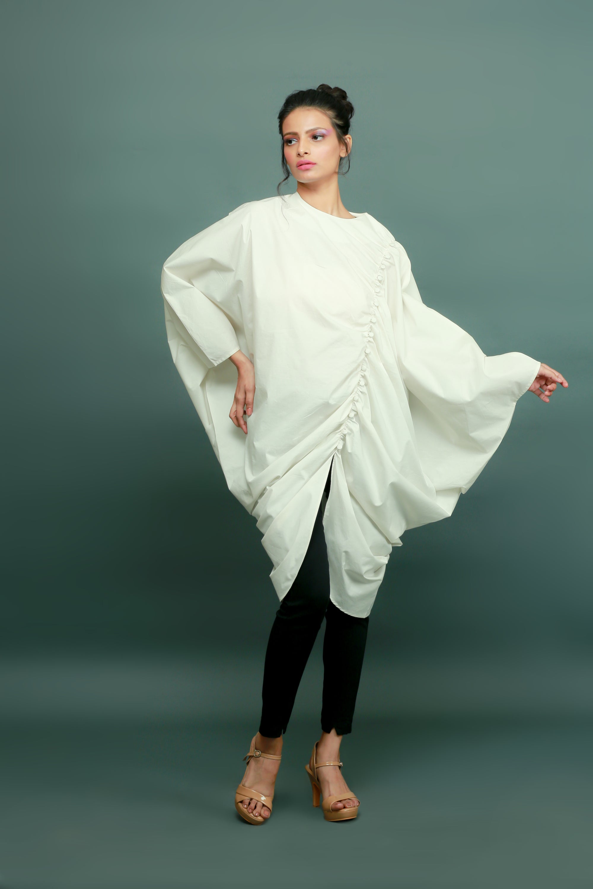 Off-white raglan sleeves top with gathers and a self-button feature on the left side.