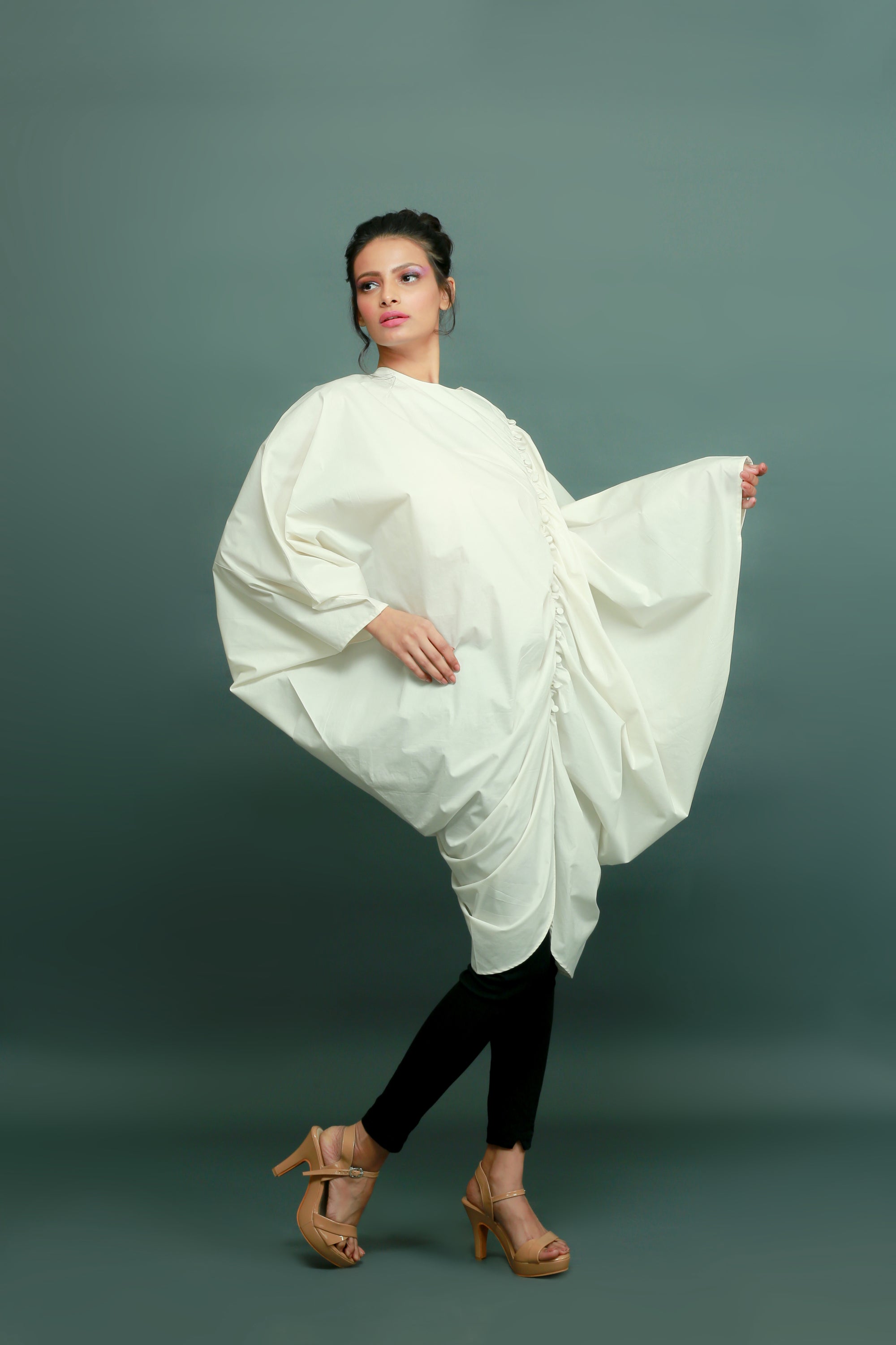 Off-white raglan sleeves top with gathers and a self-button feature on the left side.