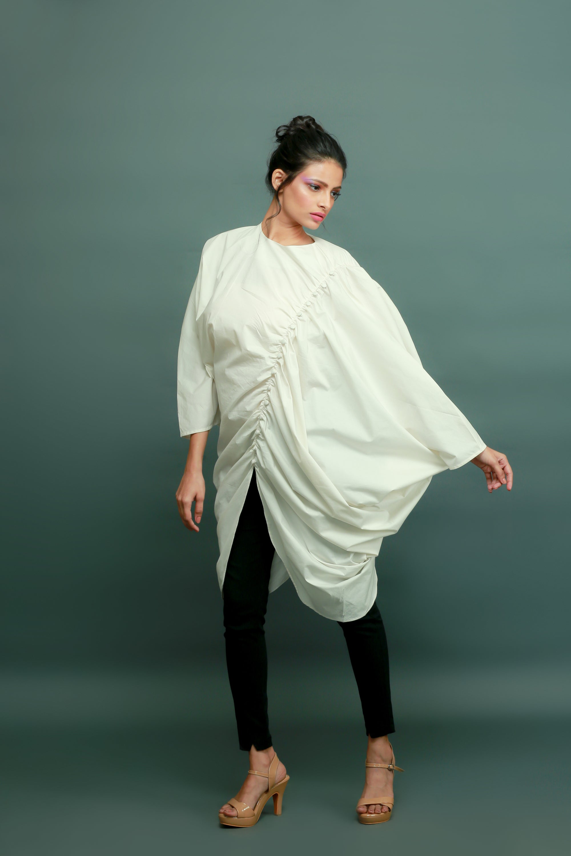 Off-white raglan sleeves top with gathers and a self-button feature on the left side.