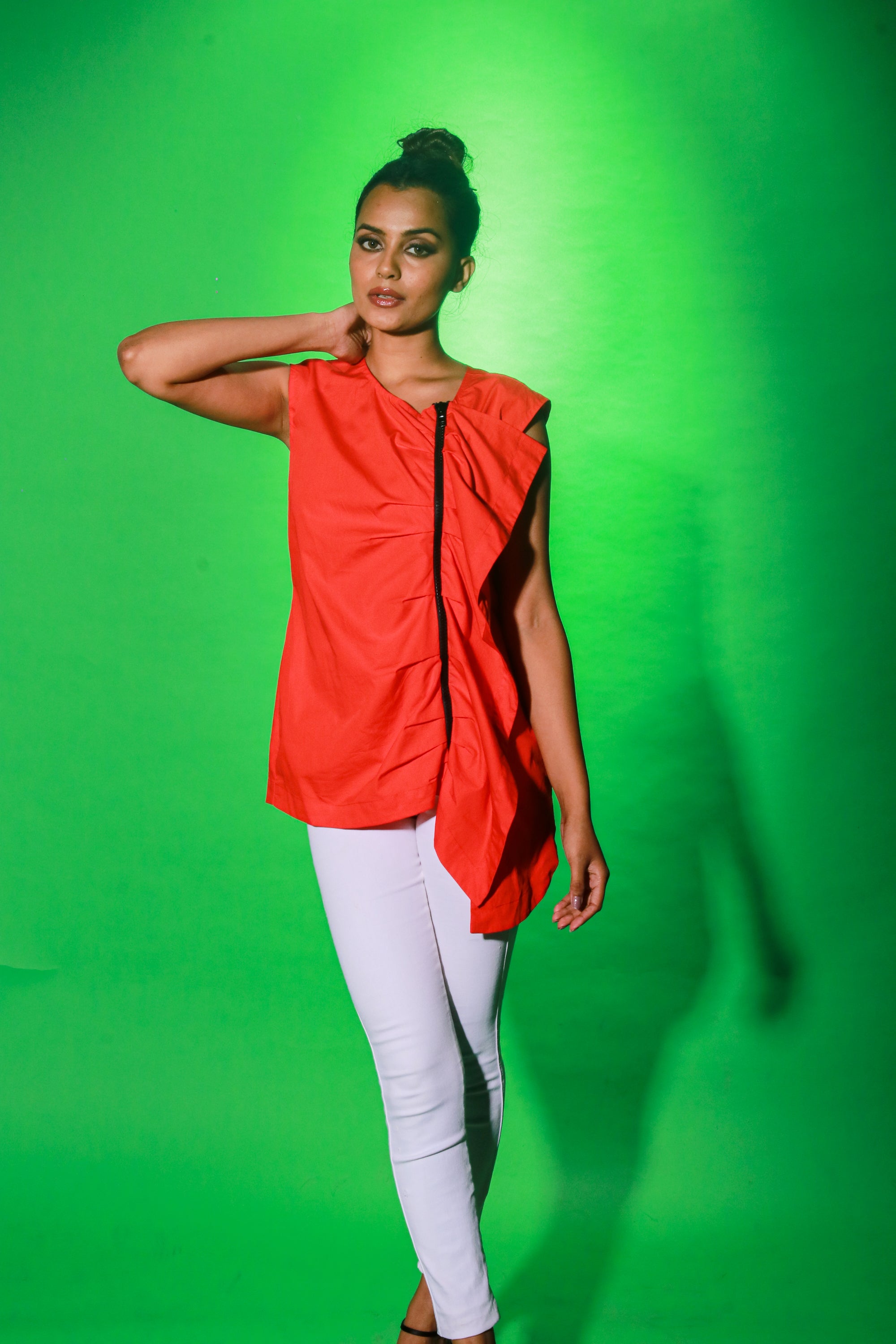 Coral sleeveless top features an off center zipper placket and frill detailing.