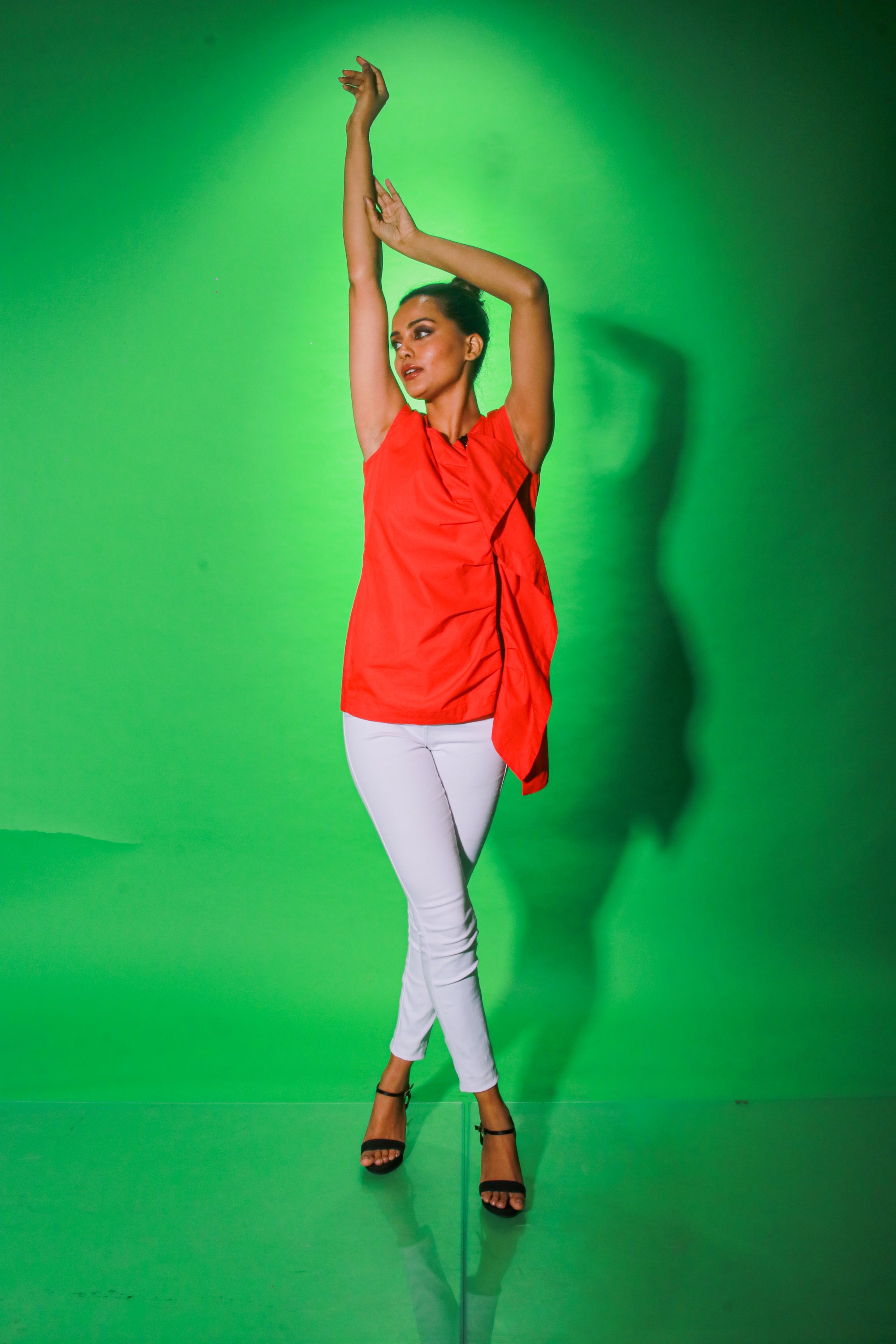 Coral sleeveless top features an off center zipper placket and frill detailing.