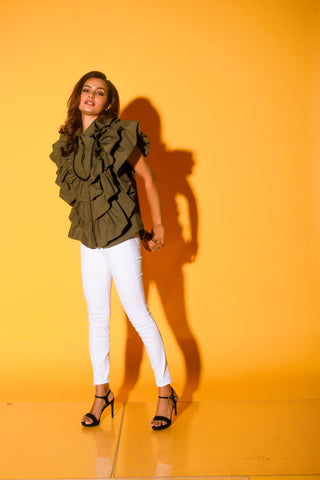 Olive green shirt features ruffles and black pipeing on the yoke.