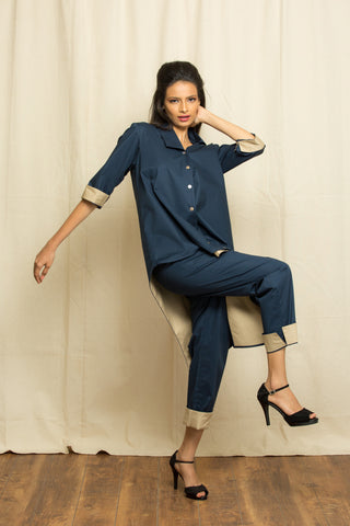 Blue co-ord set features an asymmetric top and matching pants with khaki facing detailing.