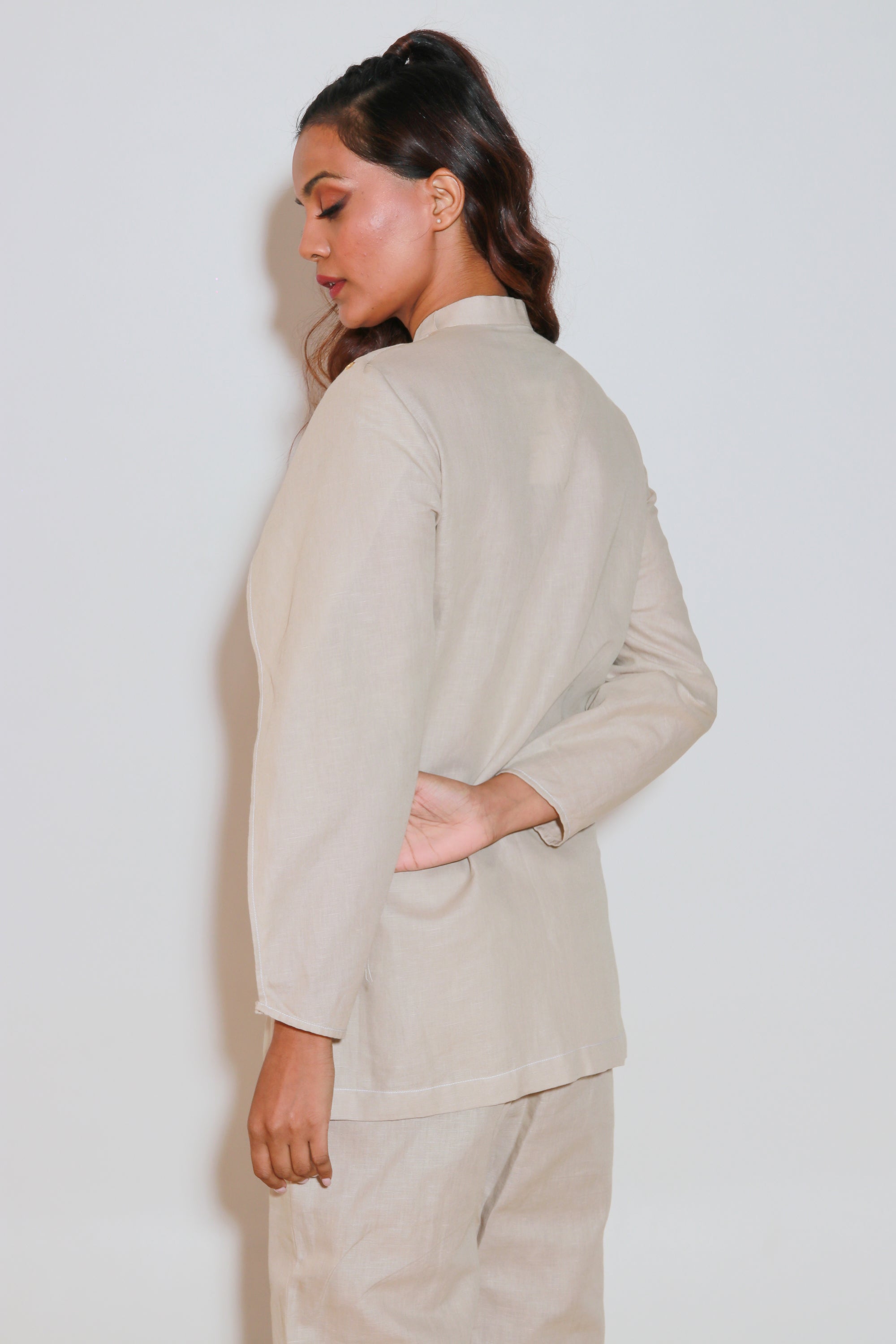 Ecru co-ord set is crafted in pure linen and features a top with eyelet collar, flap sleeves and straight pants.