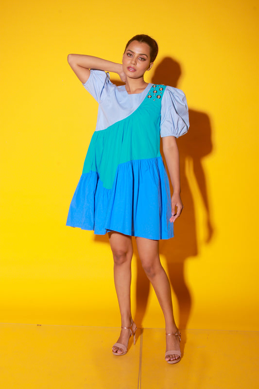 Turquoise, slate and powder blue short dress features balloon sleeves and eyelet feature on one shoulder.