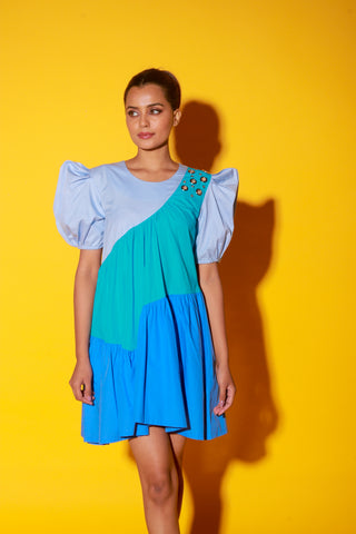 Turquoise, slate and powder blue short dress features balloon sleeves and eyelet feature on one shoulder.