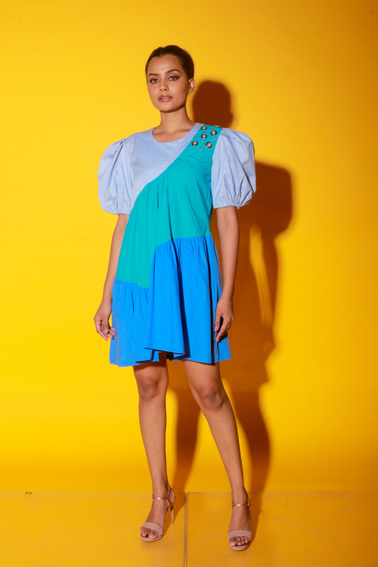 Turquoise, slate and powder blue short dress features balloon sleeves and eyelet feature on one shoulder.