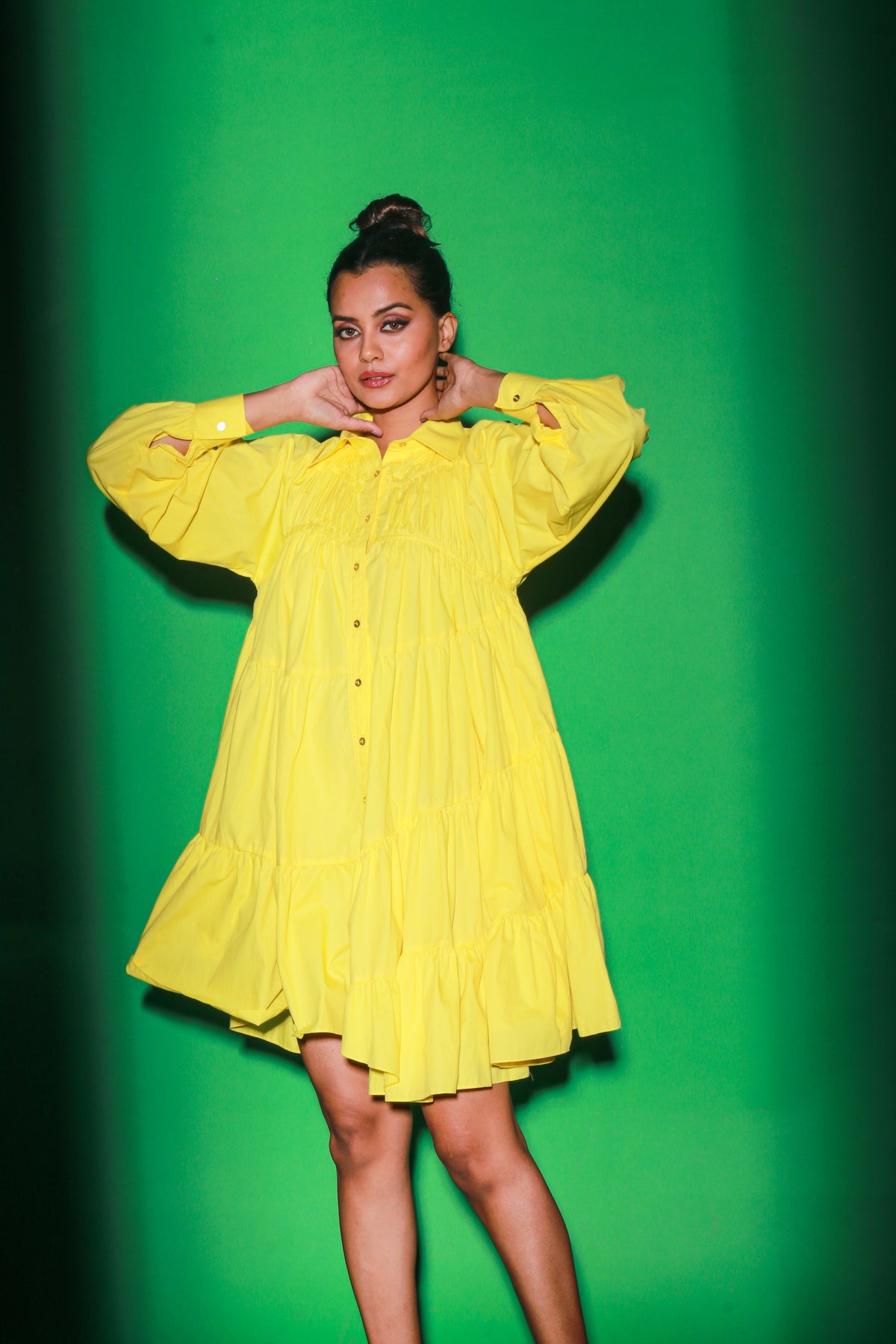 Yellow short tiered dress features a distinct collar and 3/4th sleeves.