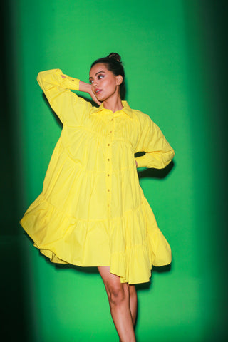 Yellow short tiered dress features a distinct collar and 3/4th sleeves.