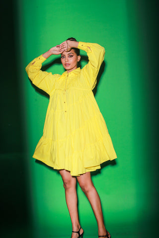 Yellow short tiered dress features a distinct collar and 3/4th sleeves.