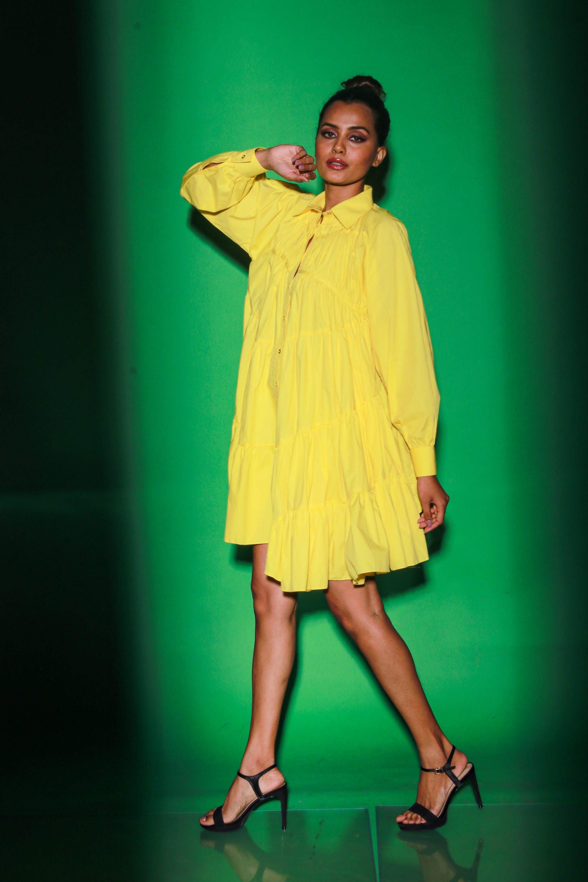 Yellow short tiered dress features a distinct collar and 3/4th sleeves.