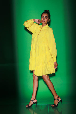 Yellow short tiered dress features a distinct collar and 3/4th sleeves.