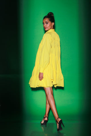 Yellow short tiered dress features a distinct collar and 3/4th sleeves.