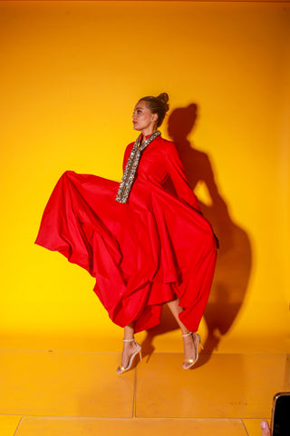 Red maxi length dress features a chinese collar with long sleeves and asymmetric balloon feature.