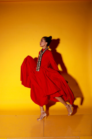 Red maxi length dress features a chinese collar with long sleeves and asymmetric balloon feature.