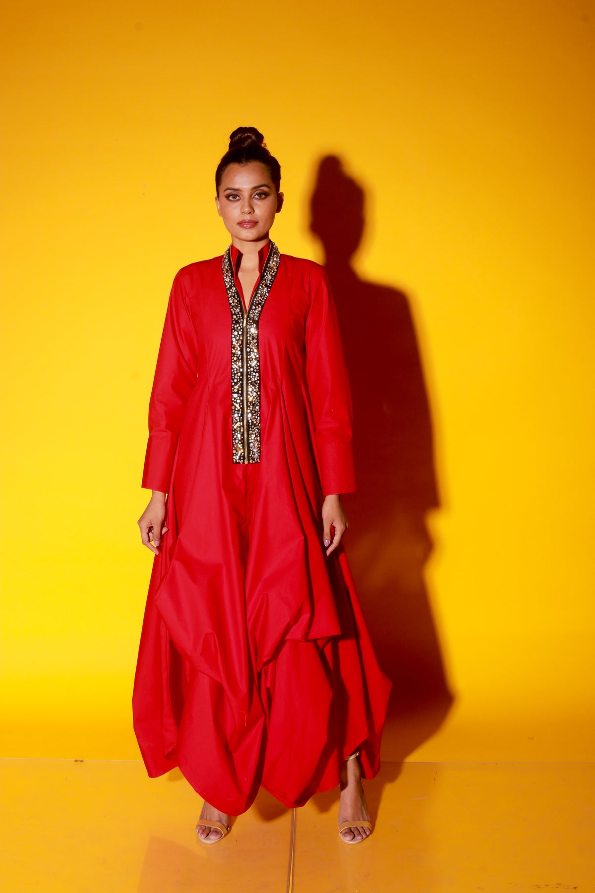 Red maxi length dress features a chinese collar with long sleeves and asymmetric balloon feature.