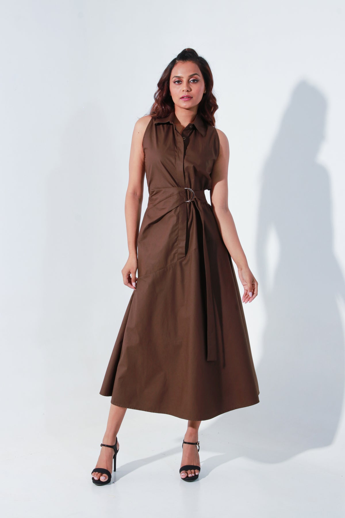 Edgar dress in brown with an attached saddle belt and waist cut-outs on the side.