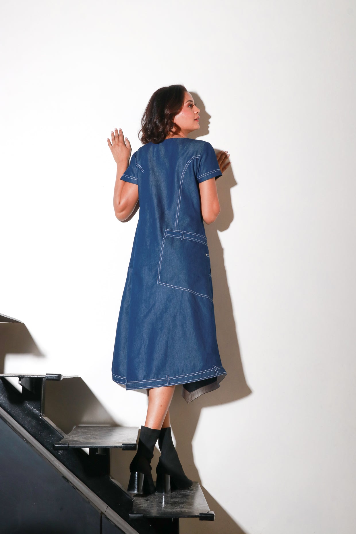 Denim asymmetric dress with zipper flap feature.