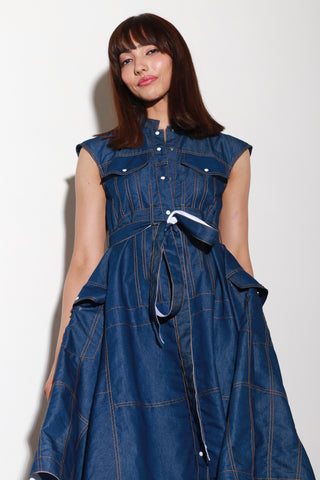 Sleeveless denim maxi dress with a waist belt and asymmetric flare on the sides.