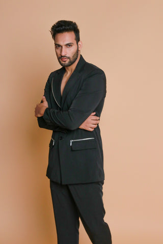 Black jacket with zip detailing and narrow pants.