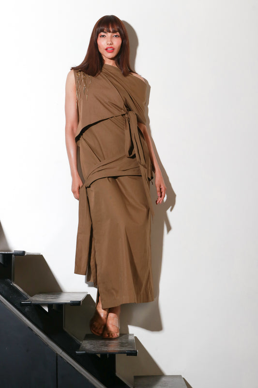 Brown long tie-up dress with eyelets and chains on one side.