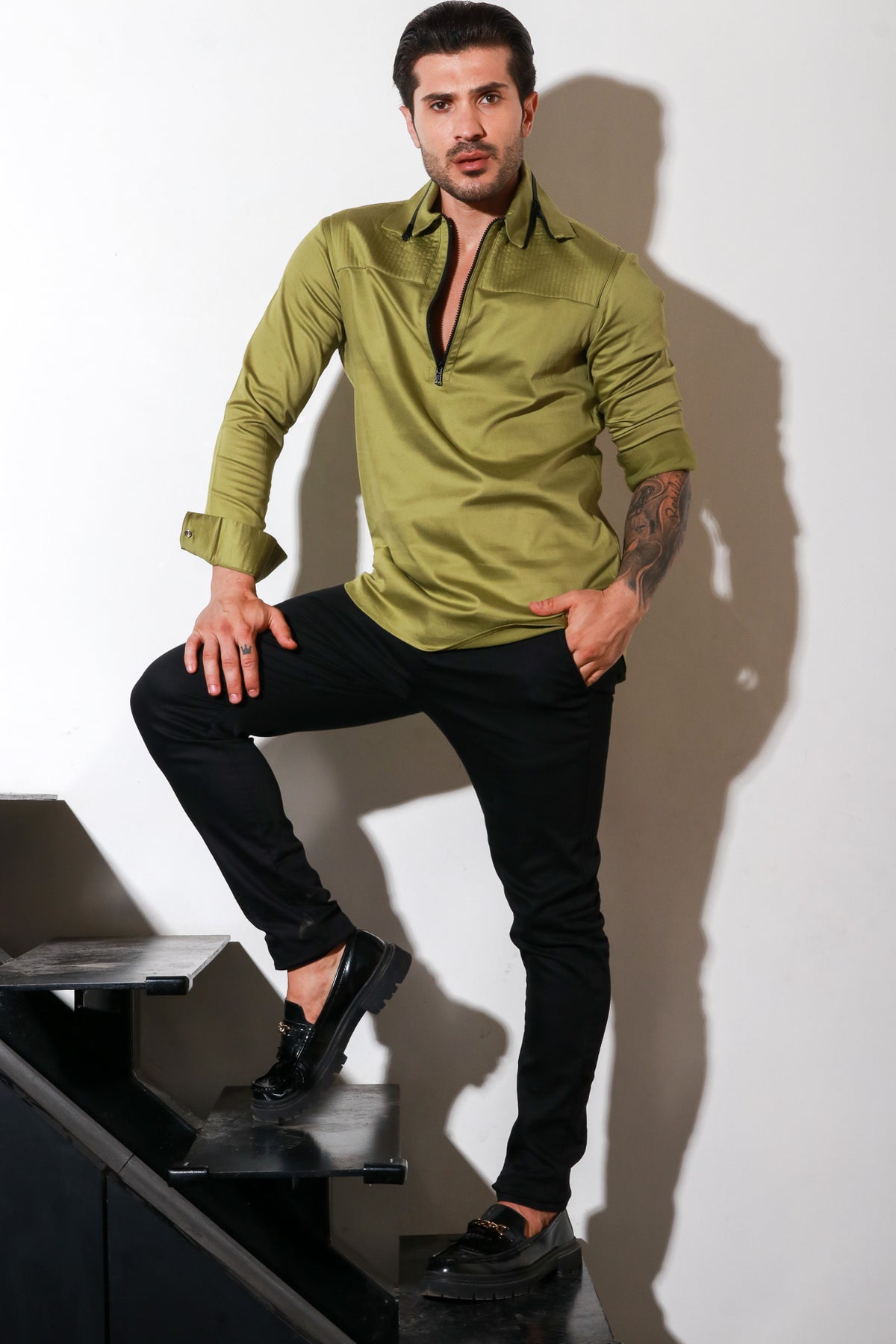 Moss green full sleeves shirt with self quilting, eyelets feature with black zipper accent.