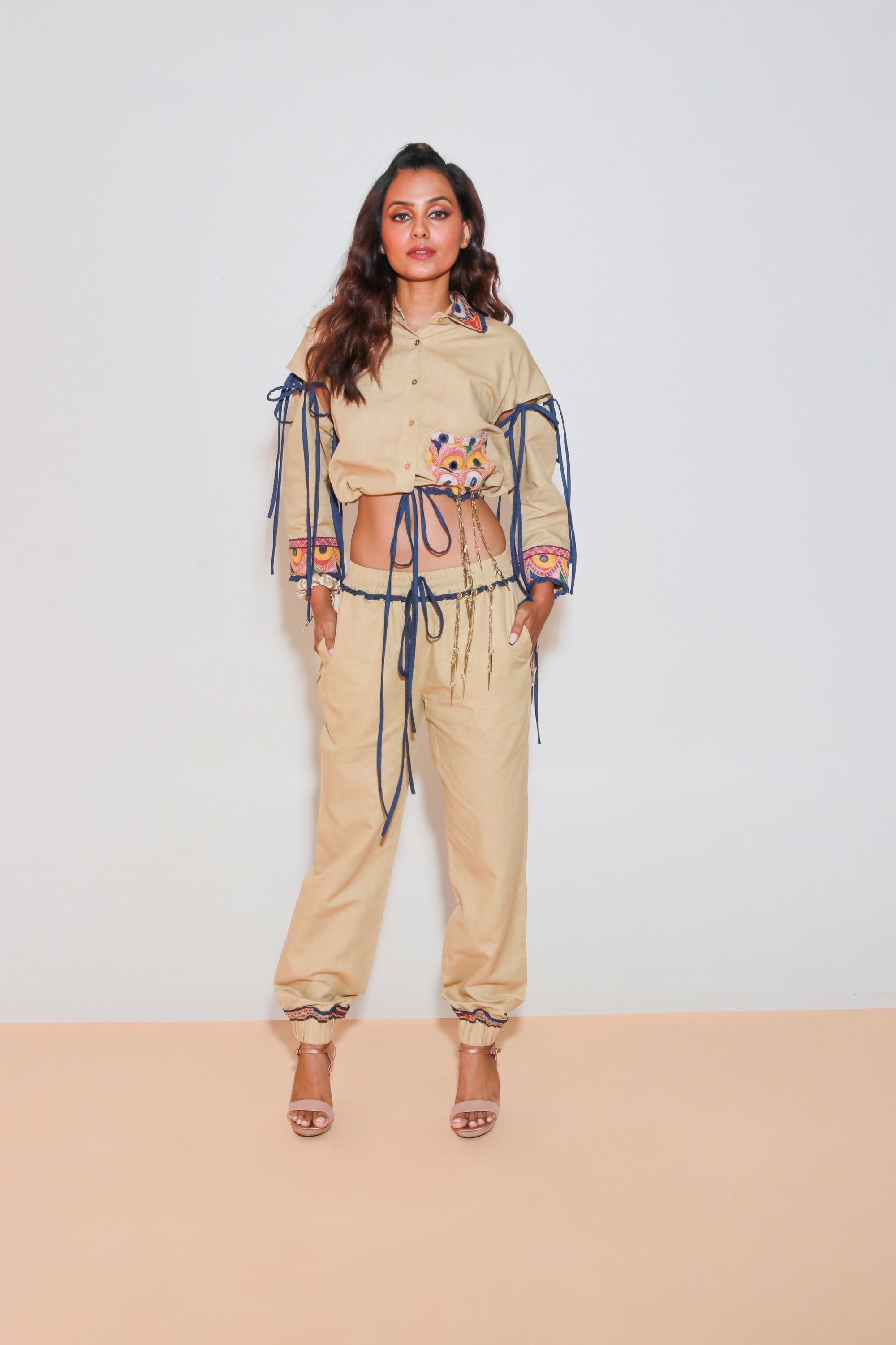Denim and khaki tie-up crop top with Kutch border, detachable sleeves, and matching jogger pants with Kutch border accents.