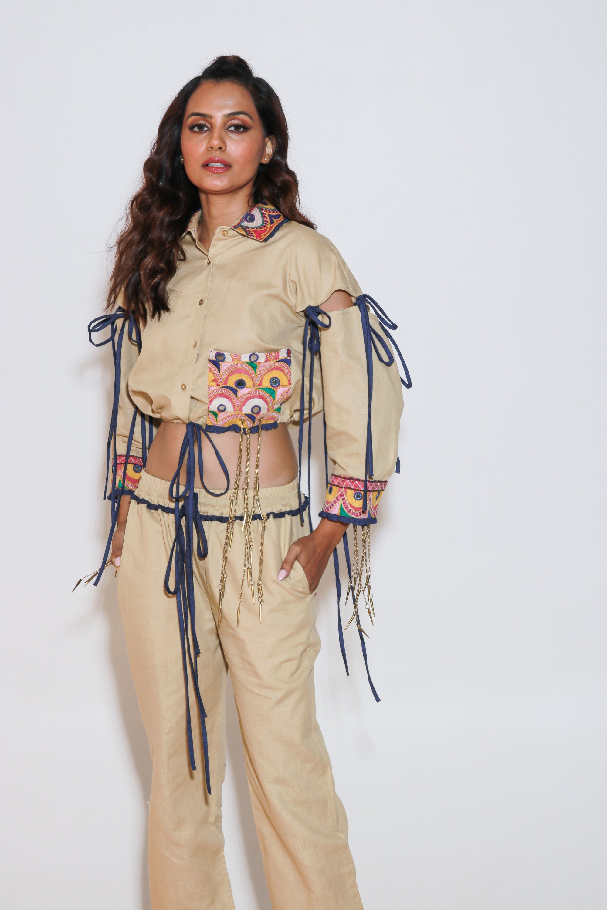 Denim and khaki tie-up crop top with Kutch border, detachable sleeves, and matching jogger pants with Kutch border accents.