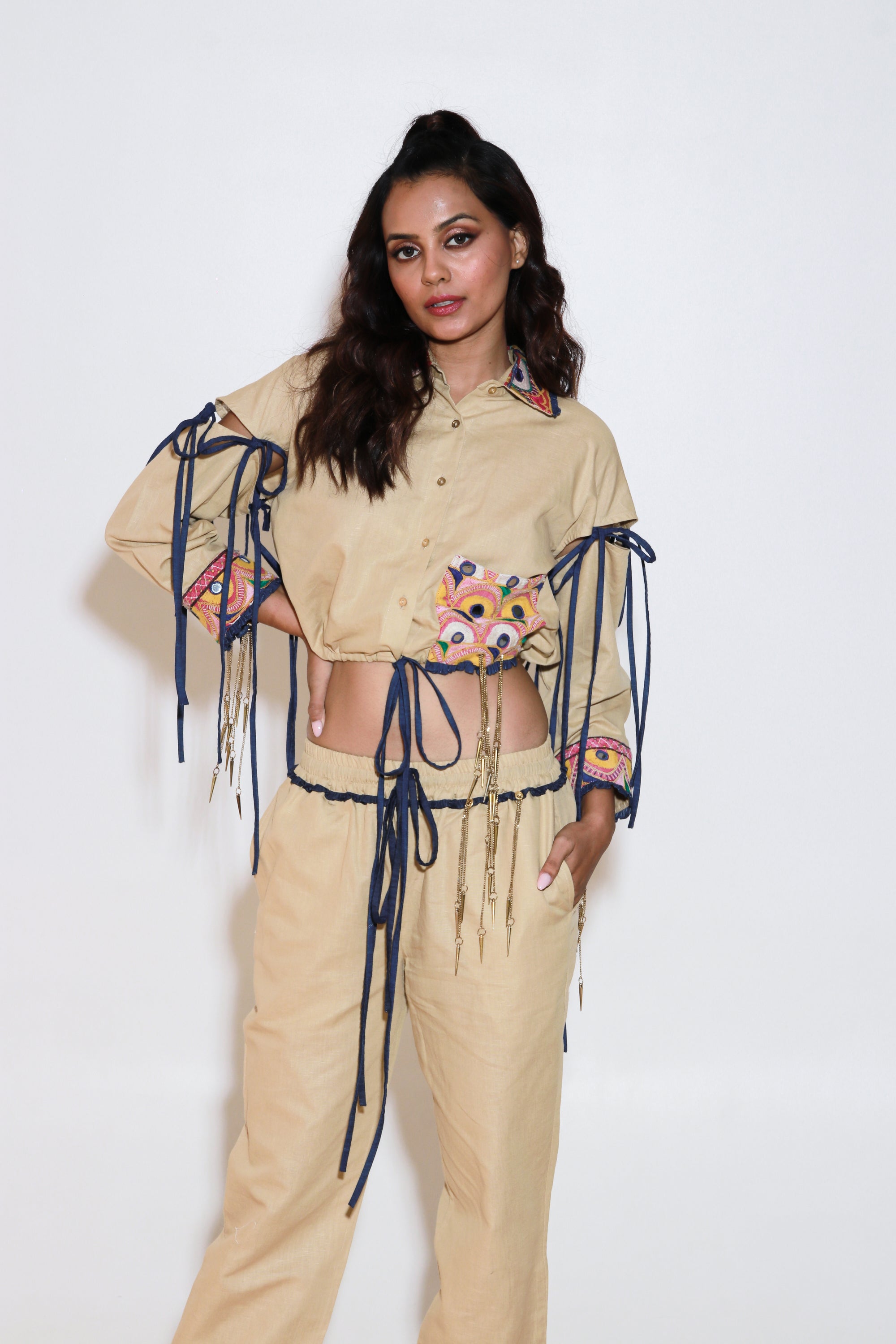 Denim and khaki tie-up crop top with Kutch border, detachable sleeves, and matching jogger pants with Kutch border accents.