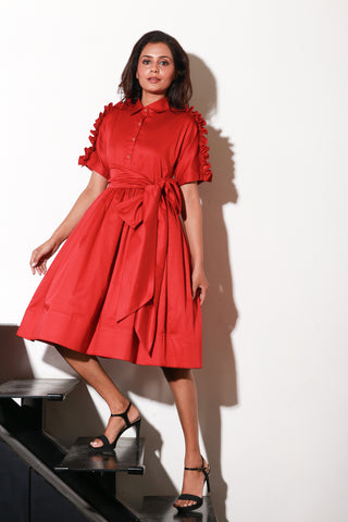 Red lady dress with waist flare and ruffle feature on shoulders and sleeves.