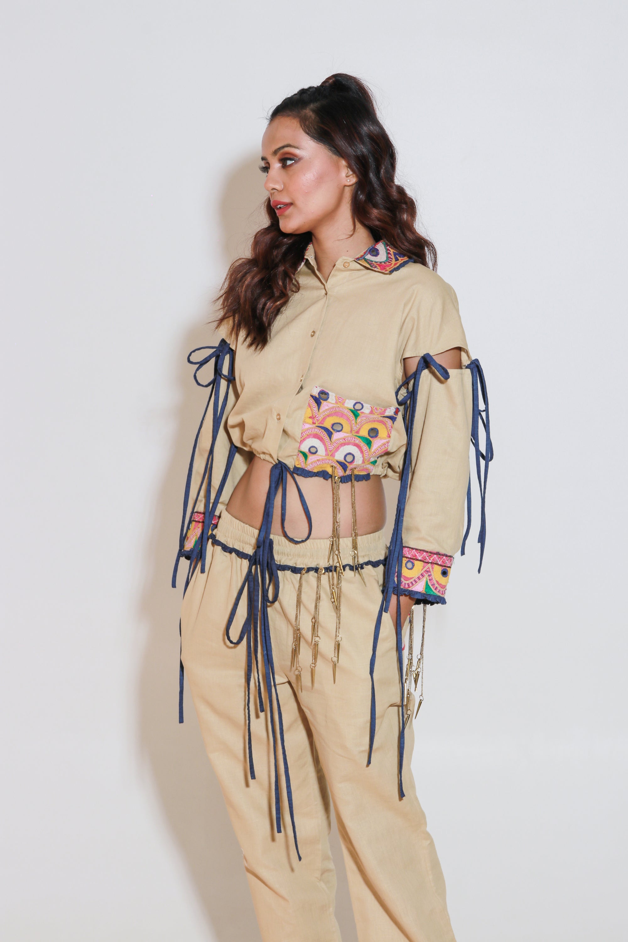 Denim and khaki tie-up crop top with Kutch border, detachable sleeves, and matching jogger pants with Kutch border accents.