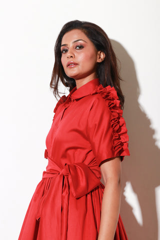 Red lady dress with waist flare and ruffle feature on shoulders and sleeves.