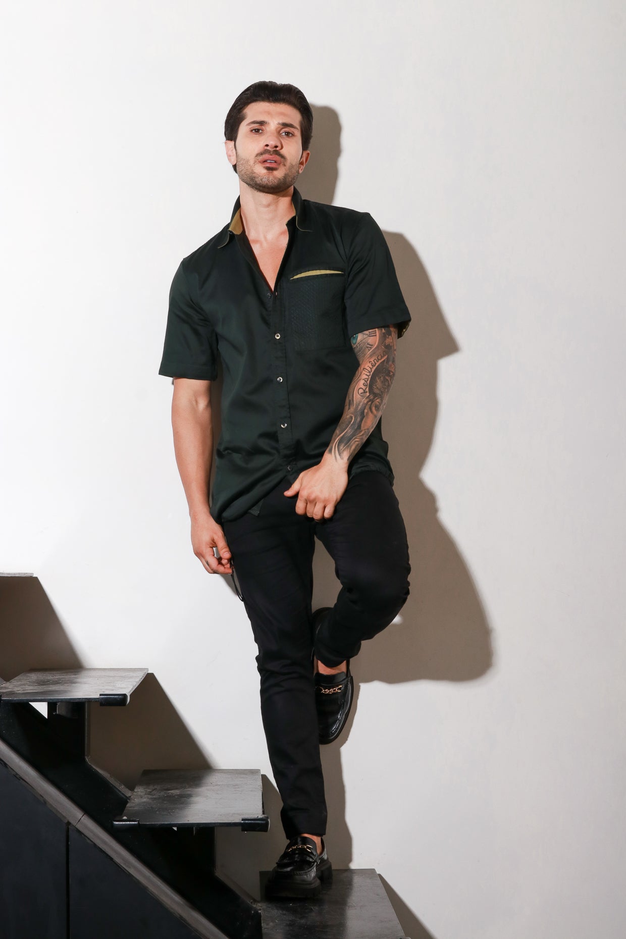 Dark green half sleeve shirt with contrast detailing and elasticated bottom feature.