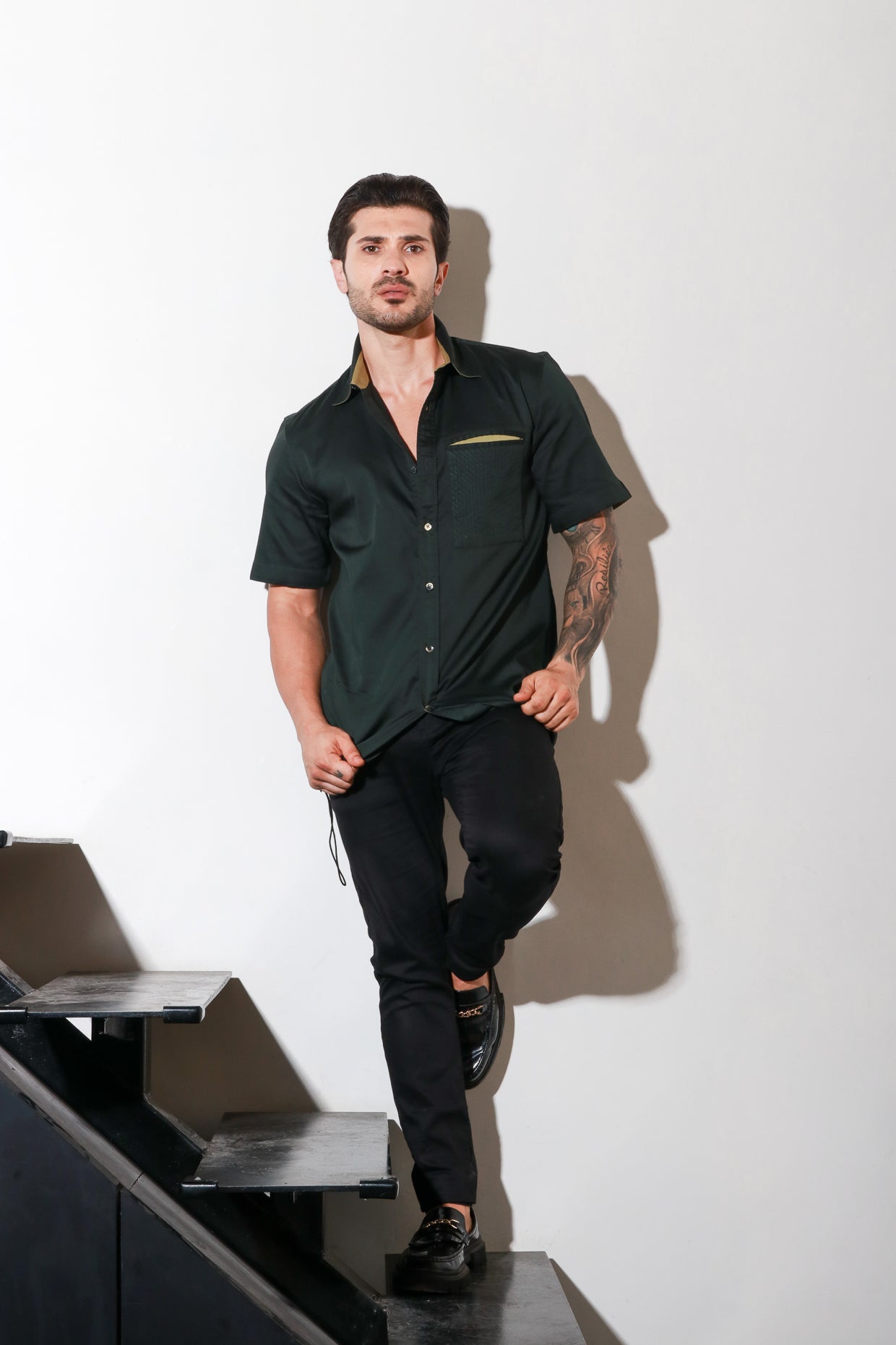 Dark green half sleeve shirt with contrast detailing and elasticated bottom feature.