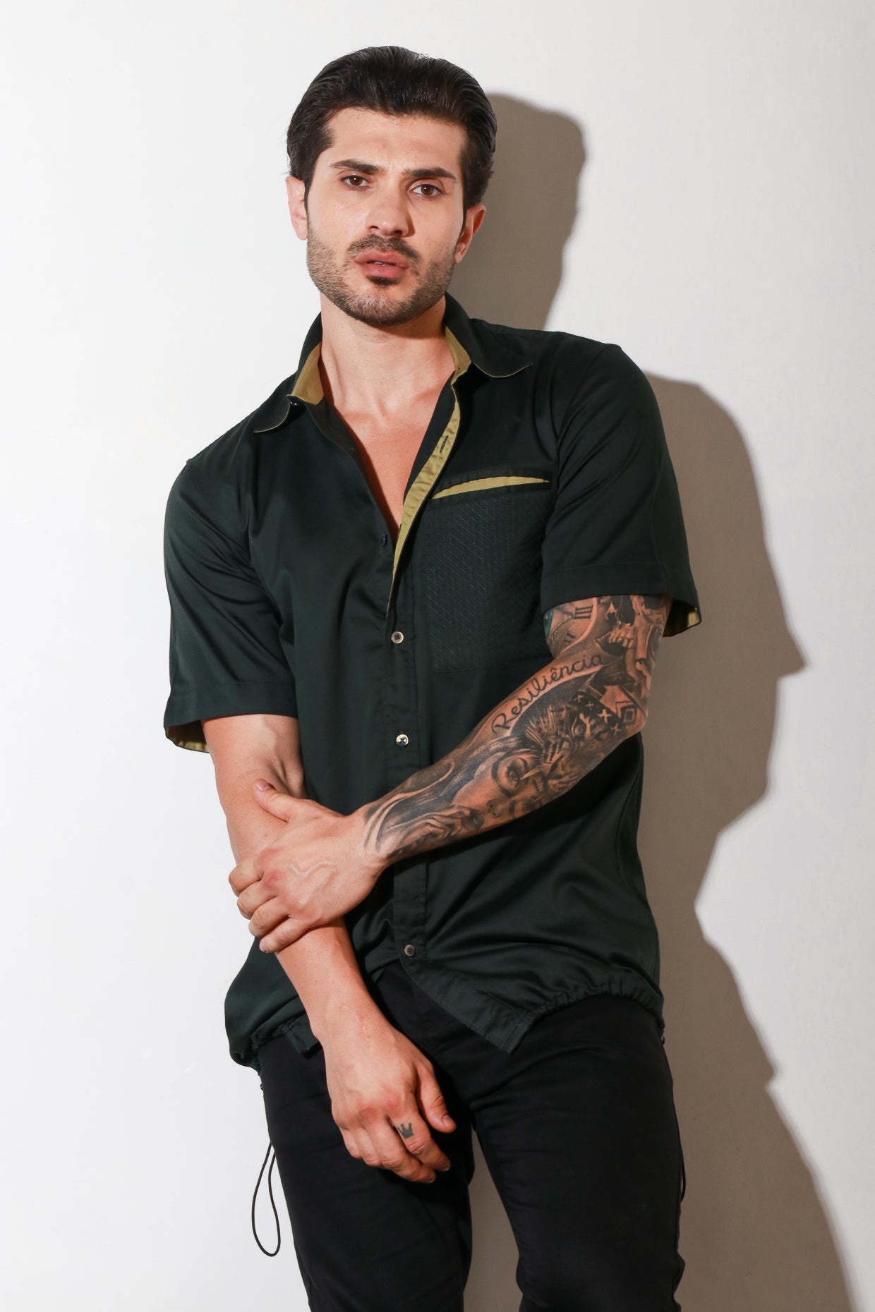 Dark green half sleeve shirt with contrast detailing and elasticated bottom feature.