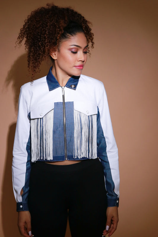 White crop jacket with white tassels, light and dark denim, and a silver zipper.