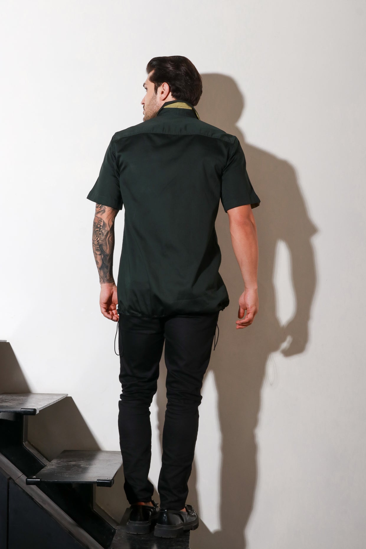 Dark green half sleeve shirt with contrast detailing and elasticated bottom feature.