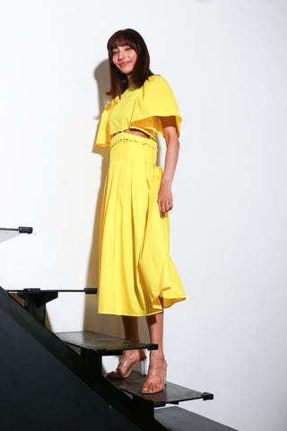 Yellow dress with a buttoned waist and box pleat.